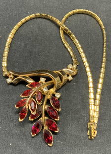 TRIFARI Gold atone Crystal Pendant Necklace: Vintage Trifari gold tone pendant necklace with crystal decorated branch motif. Signed on clasp. Drop length approx. 6 inches. Pendant measures approx. 1.75 x 2 inches. Some surface wear including scr