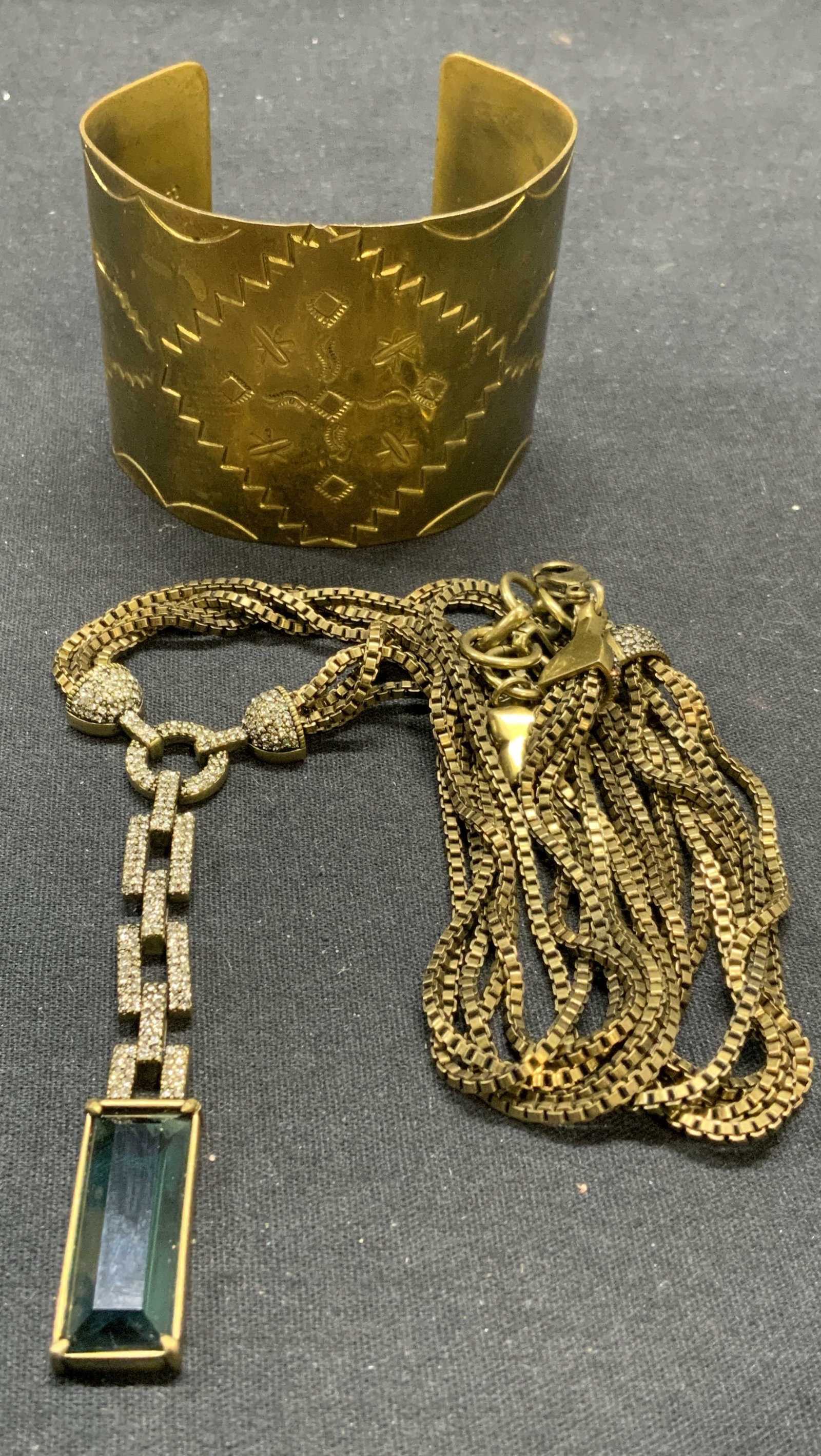 2 BCBGMAXAZRIA Pendant Necklace, LS Brass Cuff: Lot of 2 jewelry pieces. BCBGMAXAZRIA gold tone multi chain pendant necklace with crystal decoration. Designer label on hang tag. Drop length approx. 10 inches. Pendant length approx. 3 inches. LS bra