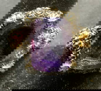 Sterling Silver 18k Gold Purple Gemstone Ring: Sterling silver and 18k gold ring with purple gemstone. Possibly spinel or topaz. Mohs scale hardness between 7.5 -8. Marked 925 18k to interior band. Ring size 7.75. Stone measures approx. .5 x 3/8 i