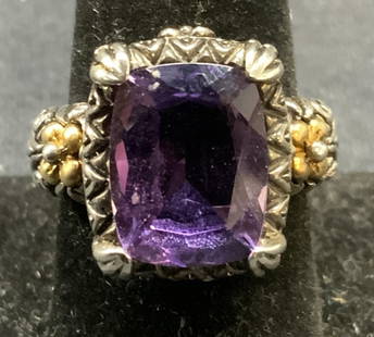 Sterling Silver 18k Gold Purple Gemstone Ring: Sterling silver and 18k gold ring with purple gemstone. Possibly spinel or topaz. Mohs scale hardness between 7.5 -8. Marked 925 18k to interior band. Ring size 7.75. Stone measures approx. .5 x 3/8 i