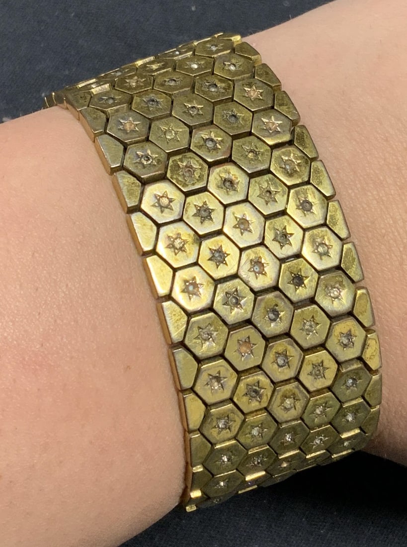 Gold Tone Mesh Chain Crystal Star Bracelet: Gold tone mesh chain bracelet with Star motif and crystal decoration. Piece has weight. Measures approx. 7 inches long. Some surface wear including loss to finish and scratching observed. Some crystal