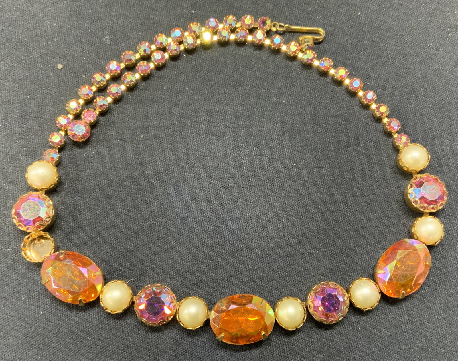 SCHIAPARELLI Pink Crystal Faux Pearl Necklace: Vintage Schiaparelli gold tone pink and orange toned crystal and faux pearl decorated necklace. Signed to underside. Drop length approx. 6.5 inches. some surface wear including scratching observed. On