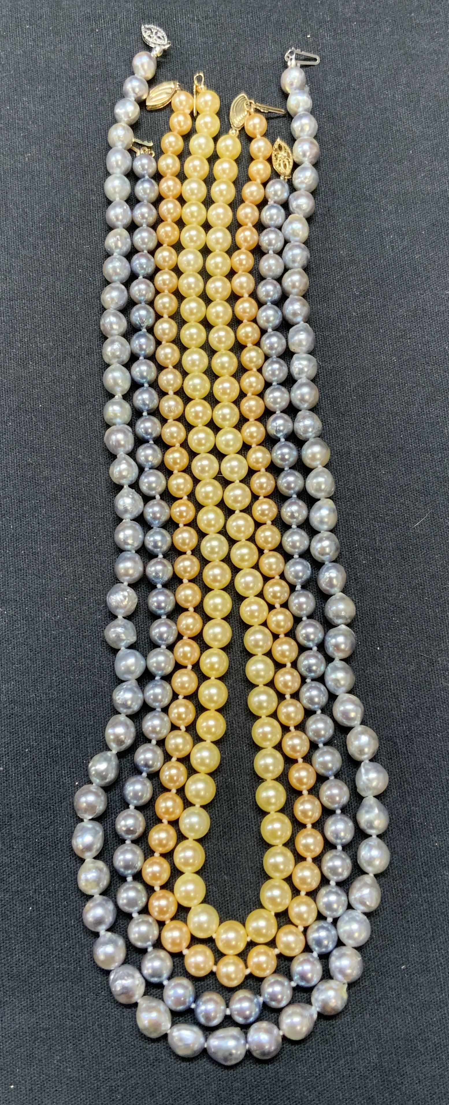 4 Tahitian, Champagne, Pink Pearl Necklaces: Lot of 4 jewelry pieces. Two pale blue-gray toned Tahitian pearl necklaces. Longer necklace measures approx 20.75 inches long, shorter approx. 17.25 inches long. Clasps marked 14k X (14k gold plated).