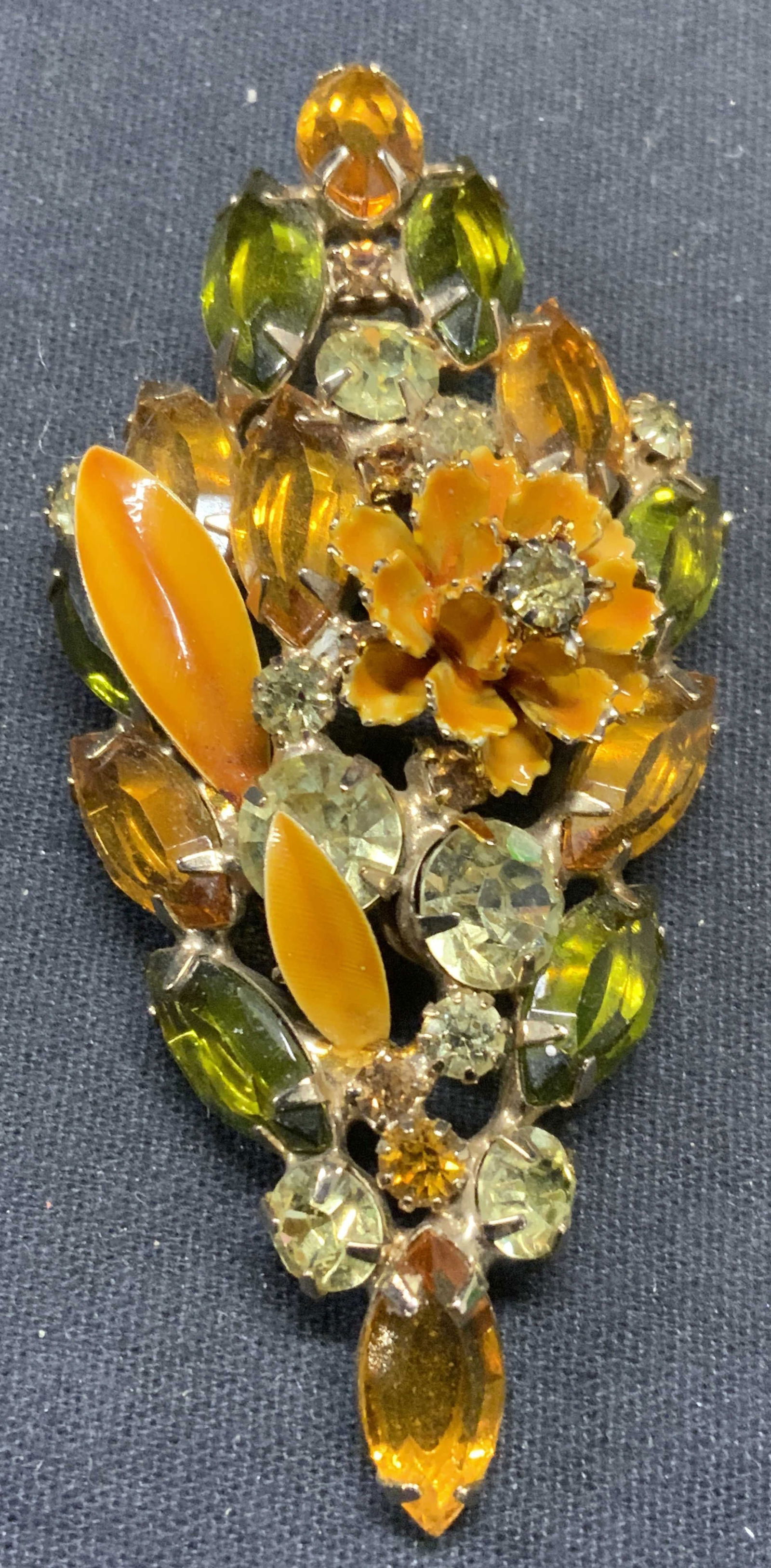 HATTIE CARNEGIE Crystal Enamel Flower Brooch: Vintage Hattie Carnegie gold tone flower brooch with orange green toned crystal and enamel decoration. Signed to underside. Hinge pin to underside. Measures approx. 3 x 1.5 inches. Some scratching obs