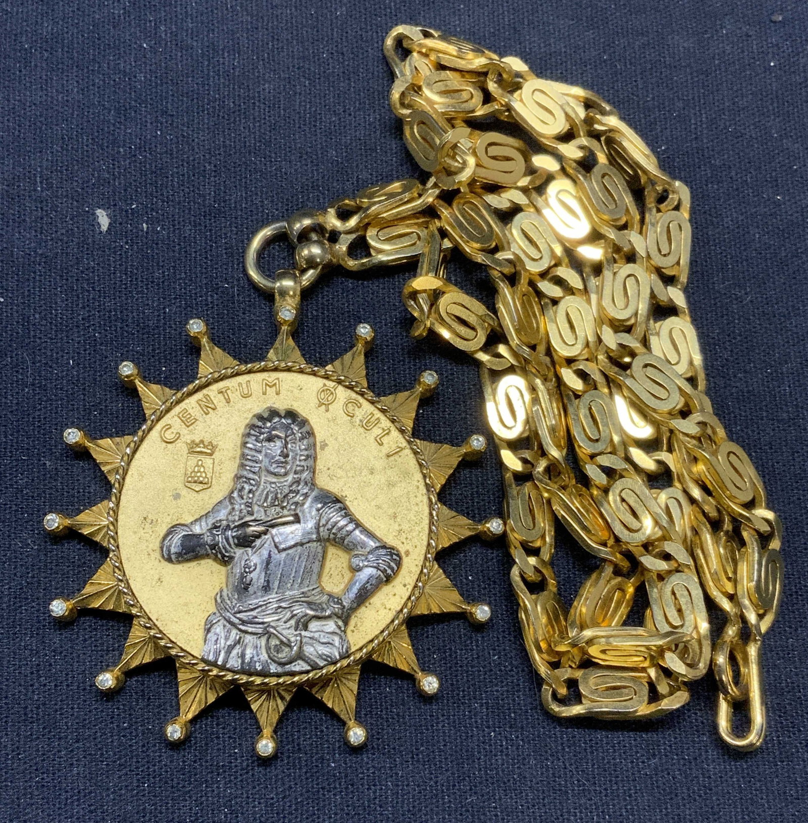 NETTIE ROSENSTEIN Coin Pendant Necklace: Vintage Nettie Rosenstein gold tone pendant necklace. Figural coin pendant, read Centum Culi. Signed to underside of pendant. Drop length approx. 11 inches, pendant measures approx. 2 inches diameter.