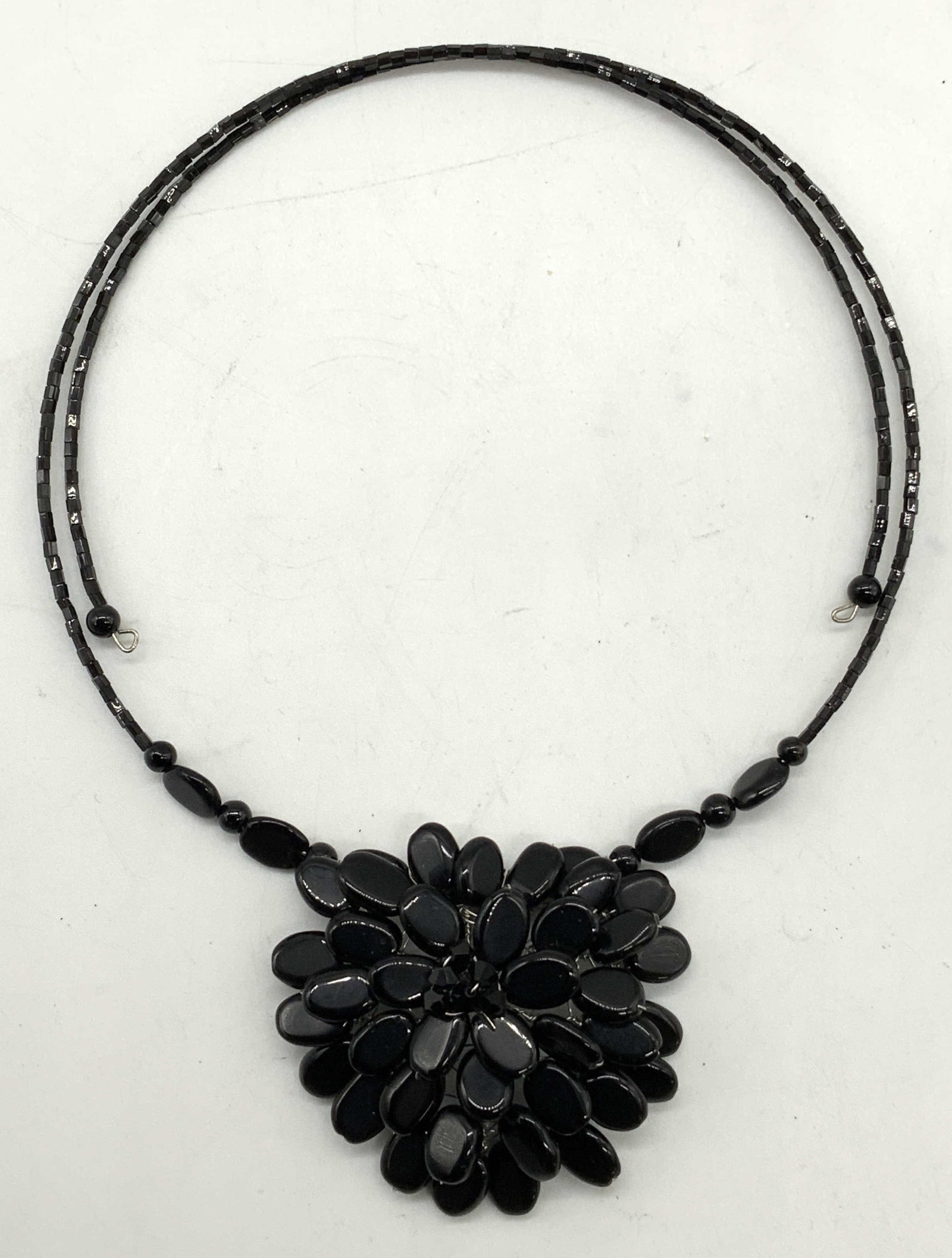 Black Beaded Pendant Choker Necklace: Black beaded pendant choker necklace. Measures approx. 4.5 inches wide, adjustable width. Pendant measures approx. 2 inches diameter. Some surface wear including scratching observed. Estate jewelry, c