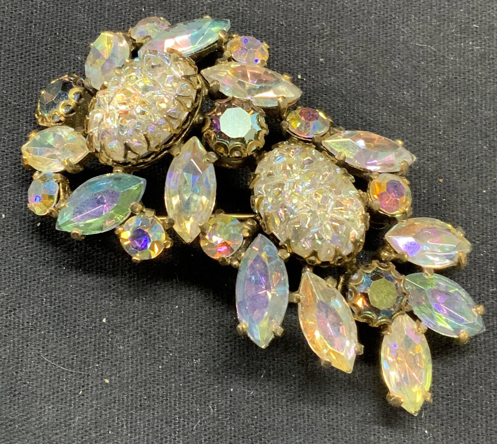 SCHIAPARELLI Opalescent Crystal Brooch 2.75in: Vintage Schiaparelli gold tone and opalescent crystal decorated brooch. Signed to underside. Hinge pin to underside. Measures approx. 1.5 x 2.75 inches. Some scratching observed. Elsa Schiaparelli was