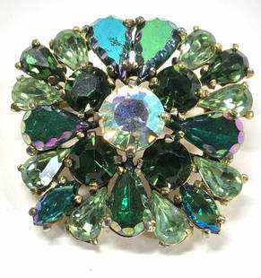 Elsa Schiaparelli Green Crystal Brooch, Sgn: Schiaparelli crystal brooch in gold tone. Several hues of green crystals with iridescent Aurora Borealis coating. Signed Schiaparelli. 1.75 x 1.75 in. Aurora Borealis brooch, Green AB crystal brooch,