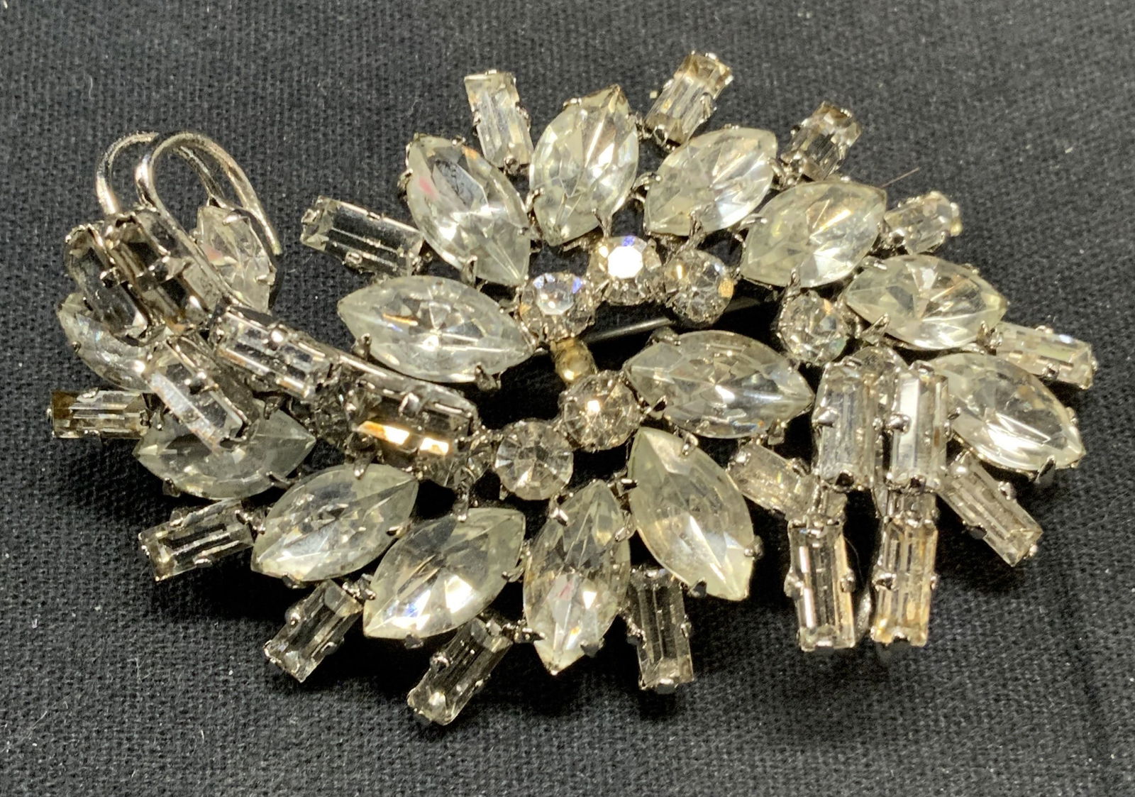 Silver Tone Czechoslovakian Crystal Brooch: Vintage silver tone colorless crystal decorated brooch. Marked Czechoslovakia to underside. Hinge pin to underside. Measures approx. 1.5 x 2.5 inches. Some scratching observed. Estate jewelry, costume