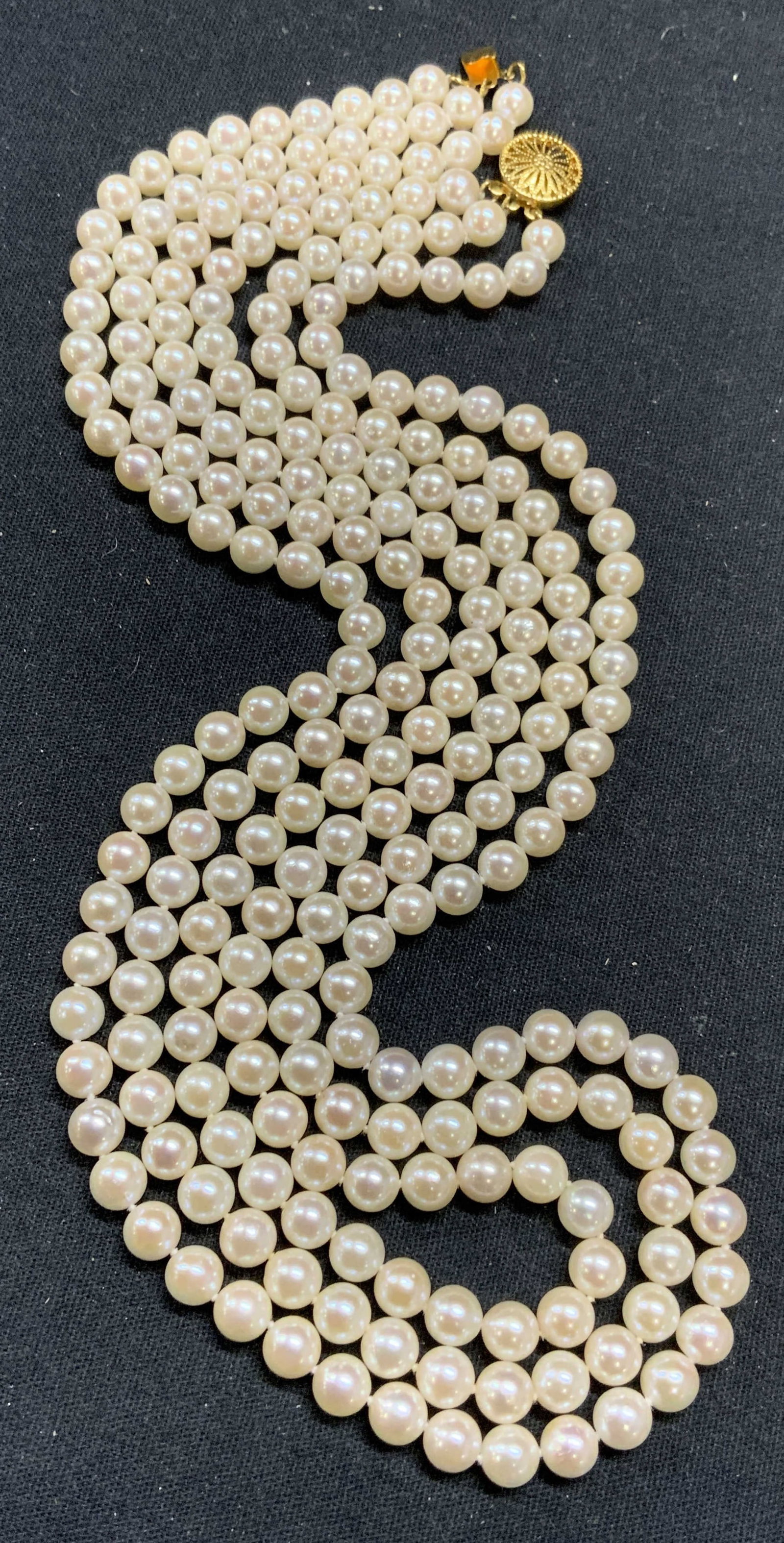 Three Strand White Pearl Necklace 451 Carats: Vintage 3 strand white pearl necklace. 14k gold filled clasp. Marked 14/20 with triangle. Drop length approx. 9.5 inches. Some scratching observed. Total weight 451 carats. Estate jewelry, fine jewelr