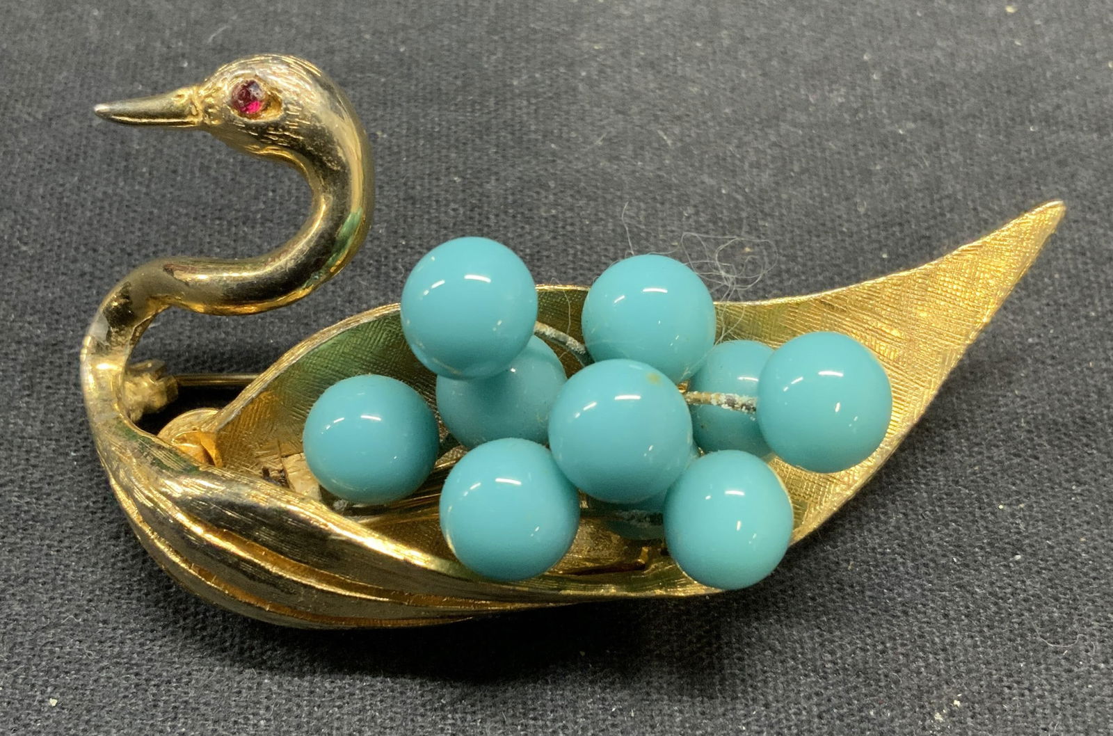 HATTIE CARNEGIE Gold Tn Blue Lucite Swan Brooch: Vintage Hattie Carnegie gold tone swan brooch with crystal and faux turquoise lucite decoration. Signed to underside. Hinge pin to underside. Measures approx. 1.5 x 2.5 inches. Some scratching observe
