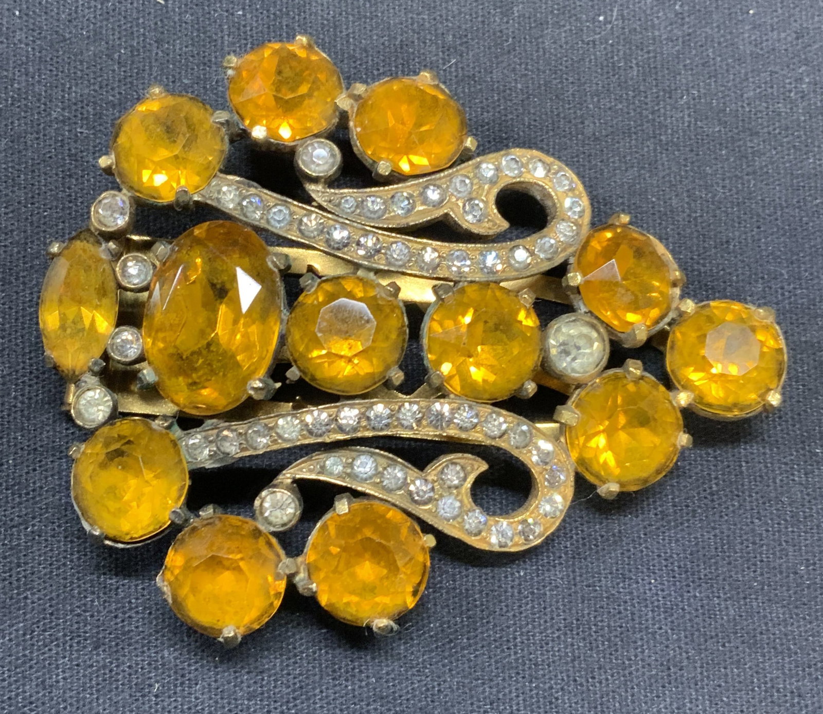 EISENBERG Gold Tone Orange Crystal Fur Clip 2.75in: Vintage Eisenberg Original gold tone orange and colorless crystal decorated fur clip. Signed to underside. Measures approx. 2.25 x 2.75 inches. Some scratching observed. Estate jewelry, costume jewelr