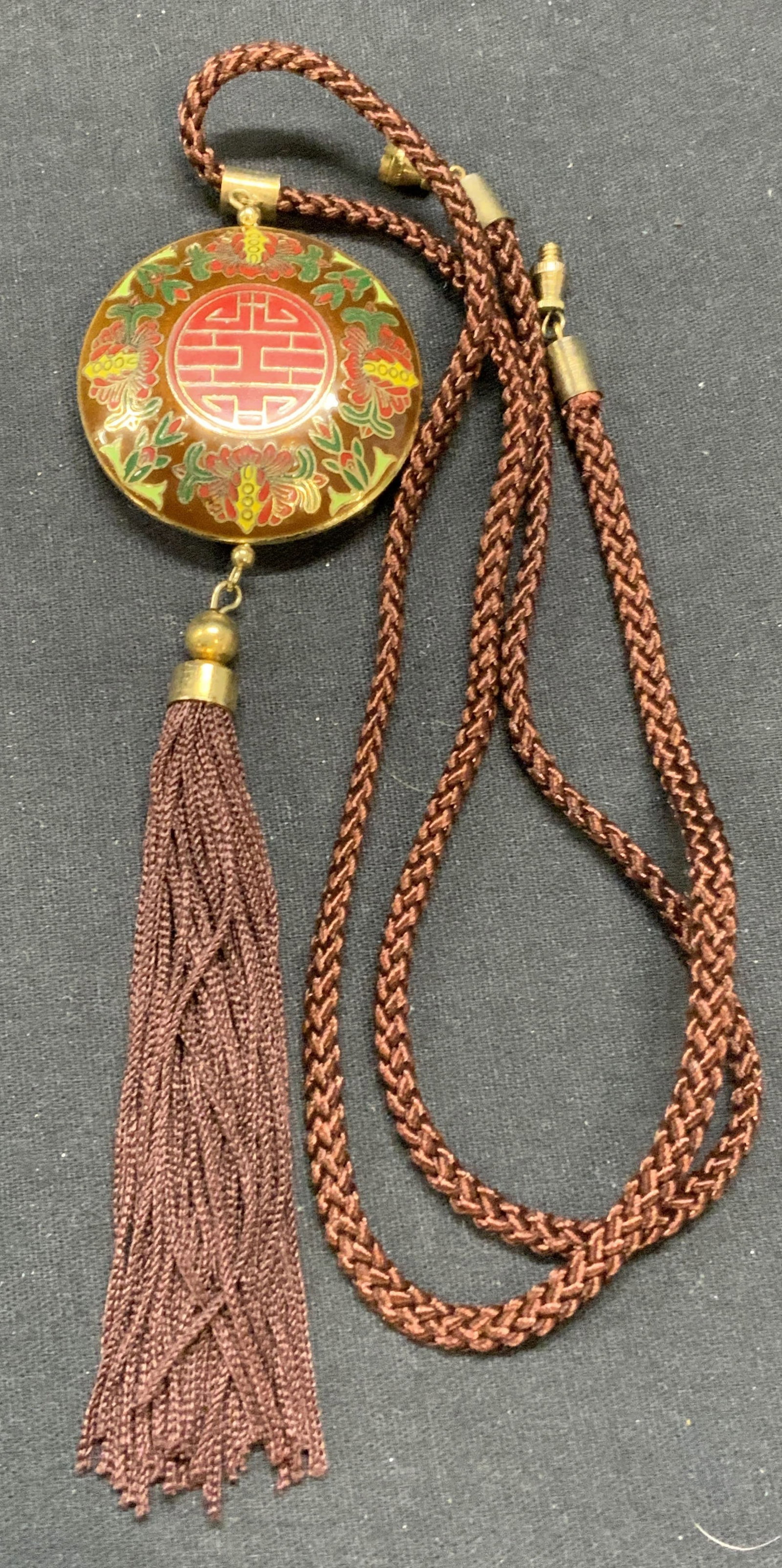 Chinese Cloisonne Enamel Pendant Necklace: Vintage Chinese enameled cloisonne pendant necklace with tassel decoration on cord. Drop length approx. 13 inches. Pendant approx. 1.5 inches diameter. Some scratching observed. Estate jewelry, costum