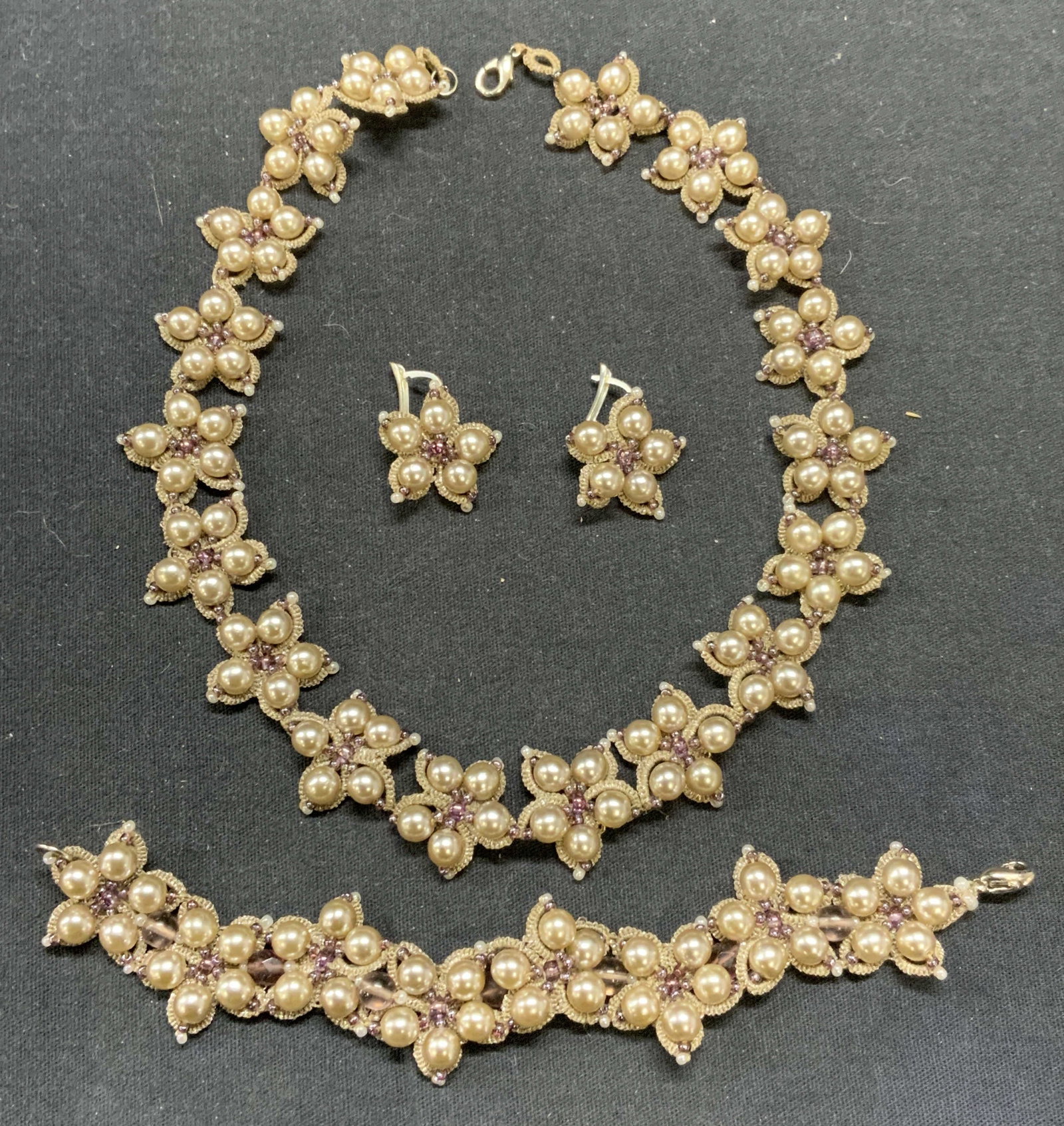 3 Faux Pearl & Crystal Necklace, Bracelet, More: Lot of 3 jewelry pieces. Vintage matching beige toned cord, faux pearl, and crystal flower necklace, bracelet, and hook back earrings. Necklace measures approx. 16 inches long. Bracelet measures appro
