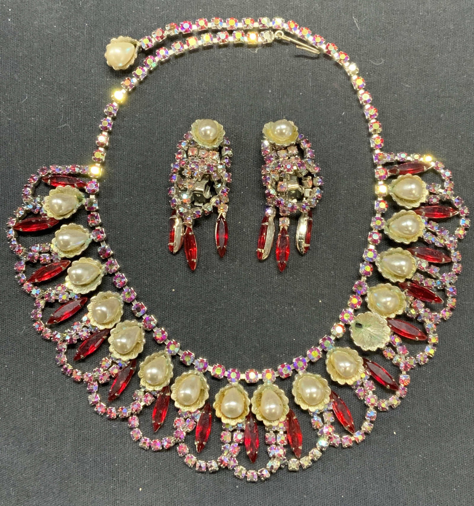 Silver Tn Faux Pearl Crystal Necklace & Earrings: Vintage matching silver tone faux pearl, colorless and red crystal decorated necklace and clip on earrings. Necklace drop length approx. 7 inches. Earring measures approx. 2 x .75 inches. Both pieces 