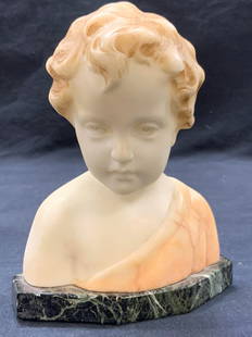 Signed Greiniet Carved Marble Child Bust: Signed on backside, possibly reads Greiniet Depicts the bust of a young boy with an off shoulder robe and wavy hair. Base is made with green stone, possibly marble. Approx 6.5 inches tall and 5.5