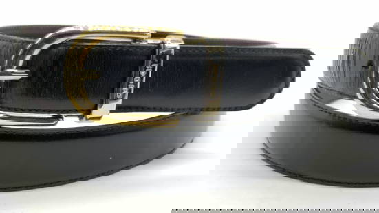 GUCCI Black Leather Designer Belt, Italy: Marked on band of belt. Gucci, Made in Italy. 100.40. 036.2194.0963.0 Black leather belt with silver and gold toned metal buckle with backside of band being a deep purple hue. Buckle is also marked Gu