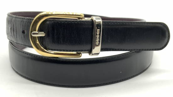 GUCCI Black Leather Designer Belt, Italy: Marked on band of belt. Gucci, Made in Italy. 100.40. 036.2194.0963.0 Black leather belt with silver and gold toned metal buckle with backside of band being a deep purple hue. Buckle is also marked Gu