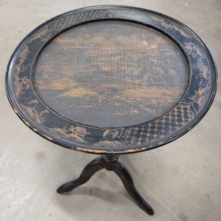 Antique Asian Lacquered Pedestaled Side Table: Table is antique. Piece is black toned & lacquered wood. Piece has pedestaled base, circular top & hand painted gold toned landscape, floral & leaf detail. Table measures approx 20.5 inches tall