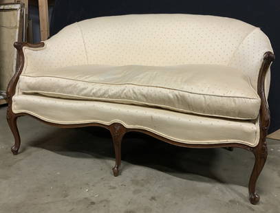 Vintage French Upholstered Settee Loveseat: Settee is vintage with carved wooden frame. Piece has cream toned upholstery with diamond shape pattern detail. Some edges of upholstery have double welting. Sofa measures approx 53 inches long 30 inc