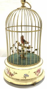 Chirping Bird in Brass Birdcage Music Box, Germany: Vintage Victorian brass birdcage with a singing bird in cage, for hanging or for table display. Lower part is painted Toleware on 3 brass knobbed feet. Underside has a wind up and on/ off switch. Meas