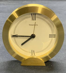 Tiffany & Co Heavy Round Brass Swiss Clock: Vintage Tiffany & Co heavy round brass Swiss clock. Trademarked on clock face. Marked Swiss to reverse. Not tested for function. Measures approx. 3.5 x 3 3/8 inches. Some surface wear including scratc