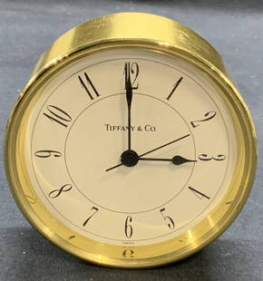 Tiffany & Co Round Brass Swiss Clock: Vintage Tiffany & Co round brass Swiss clock. Trademarked on clock face. Numbered 215728 and marked Swiss to reverse. Not tested for function. Measures approx. 3 5/8 x 1.5 inches. Some surface wear in