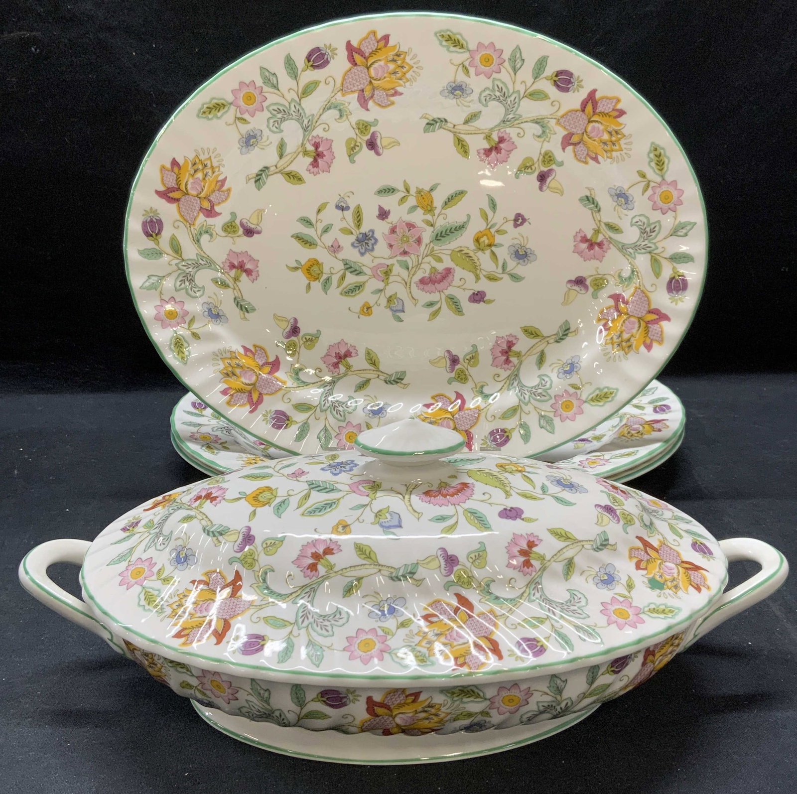 Lot 4 Minton China Haddon Hall Platters & Tureen: Lot of 3 Minton English bone china platters and 1 lidded tureen in Haddon Hall pattern. All pieces trademarked to undersides. Made in England. Platters measure approx. 13.75 x 10.25 inches each. Turee