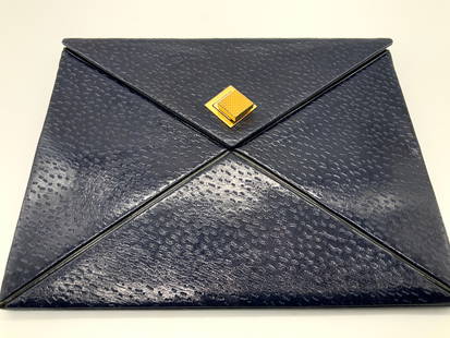 JACOMO Paris, Navy Blue Leather Envelope Clutch: Marked on interior JACOMO, Paris, leather envelope clutch in navy blue tone with Swiss diamond shaped gold toned metal latch. Interior is mustard yellow yellow. Approx 10 x 8 inches and 1 inch thick.