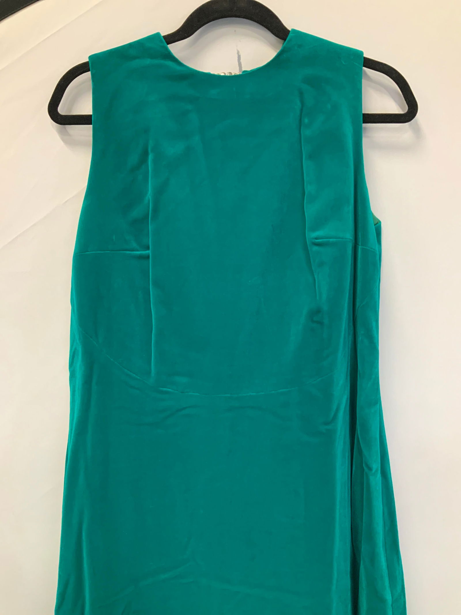Green Velvet & Deco Bejeweled Clasp Gown: Green velvet A- Line Sleeveless Gown , fully lined. No designer labeled. Waist 34-35 in. Hips 40-41 in. Length 60 in. Little lower in back. This dress has a high collar and a low exposed backside , cr