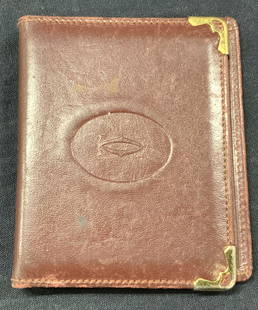 Cartier Leather Compact Mirror Card Folder, Paris: Marked on interior, a gift from Cartier, Paris A maroon toned leather card holder with one side with a compact mirror on the interior and card pocket on other side. Stamped on cover and interior with