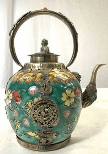 Vntg Asian Porcelain Teapot W Metal Overlay & Lid: Teapot is vintage. Piece is hand painted and porcelain with white metal overlay detail. Teapot includes lid with foo dog detail. Other areas of overlay have dragon detail. Piece has arched handle. Pie