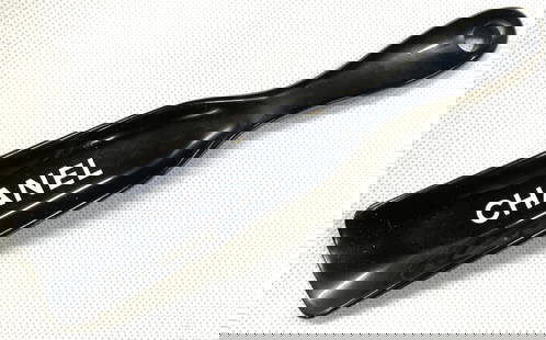 CHANEL Crystal Tex Shoe Horn: Black crystal Tex shoe horn with Chanel on the arch, back toned composite and marked Box 5200 Westport CT. 06881 Approx 7 inches long. Moderate scratches observed from age and use. Chanel designer sho