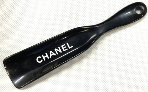 CHANEL Crystal Tex Shoe Horn: Black crystal Tex shoe horn with Chanel on the arch, back toned composite and marked Box 5200 Westport CT. 06881 Approx 7 inches long. Moderate scratches observed from age and use. Chanel designer sho