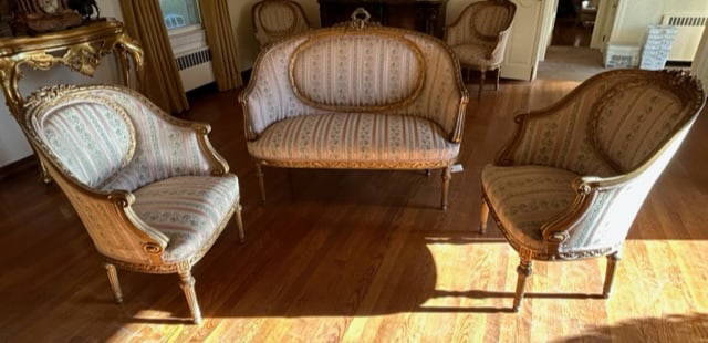 Set 3 Antique French Gilt Louis XVI Seating Group: Two arms chairs and one loveseat settee. Carved gilt wood throughout. Floral and foliage motifs throughout. Scrolled arms. Soft hand upholstery features stripes, florals, and foliage. Pink, beige, blu