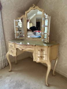 Antique Austrian Vanity W Triple Mirror: Antique Austrian vanity with a triple mirror. Adjustable lights on either end. Four drawers to obverse with dovetailing. Carved woodwork throughout. Gilt accents. Floral motif to the vanity table top.