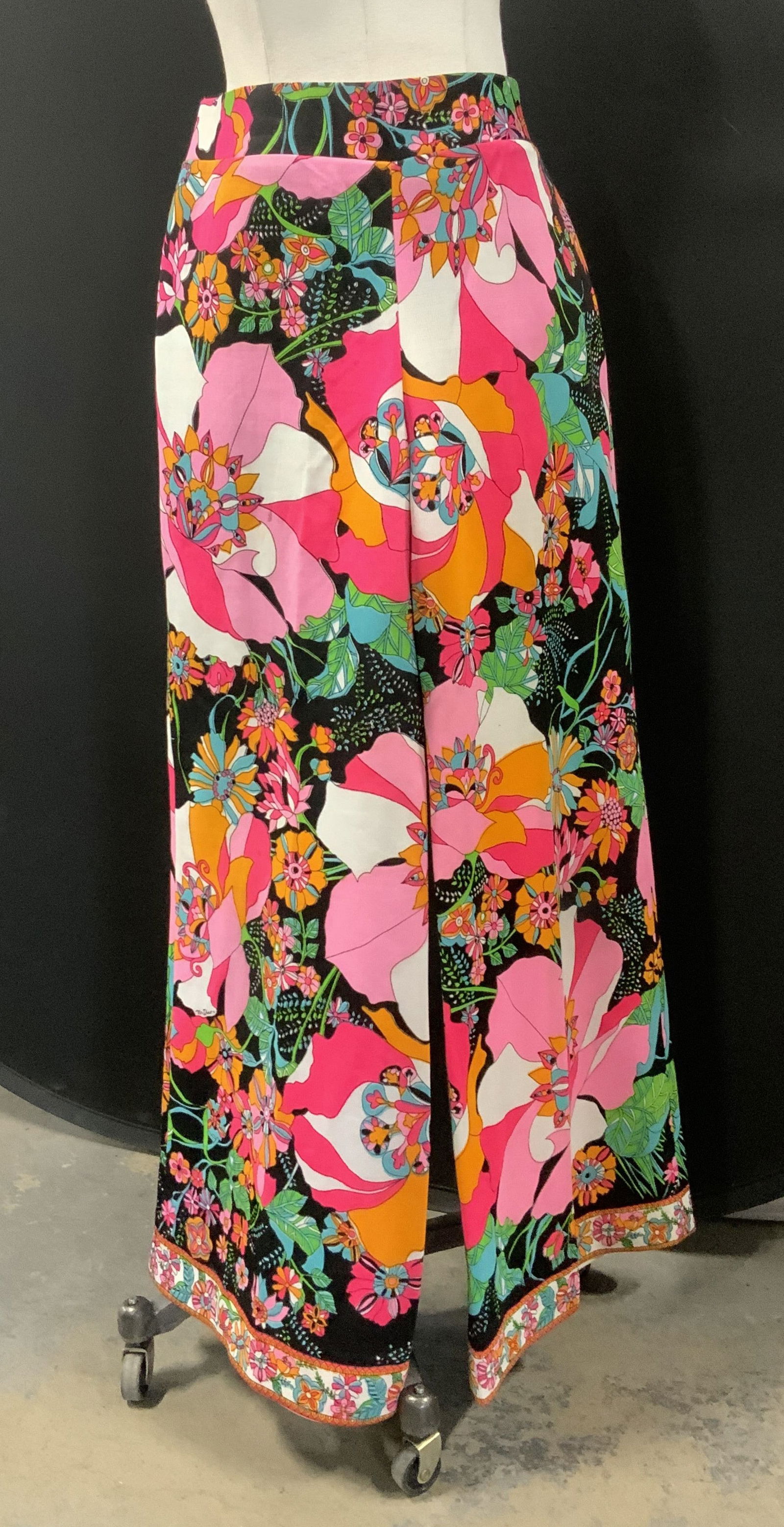 Mr. Dino for Lord & Taylor Bell Botton Pants: 1960s psychedelic flower power wide leg pants in neon colors on black background. Vintage size 16. Labeled with designer labels ‘Mr. Dino - New York Paris Florence’ and Lord & Taylor’Sports & Co