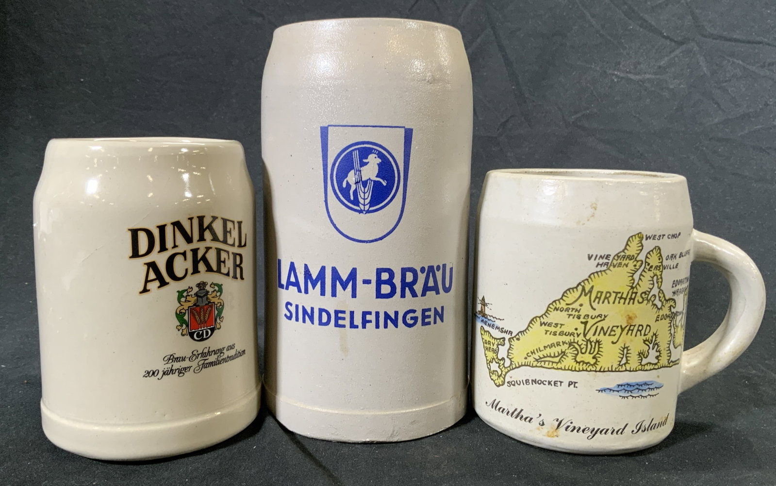 Lot3 Trademarked Ceramic Beer Steins, US, German +: Lot includes 1 DINKER ACKER, 1 LAMM BRAU SINDELFINGEN, both German beer brands & 1 Martha’s Vineyard Island beer stein, marked on underside Decorated by Frederick Studio Lake Grove, New York. Hand C