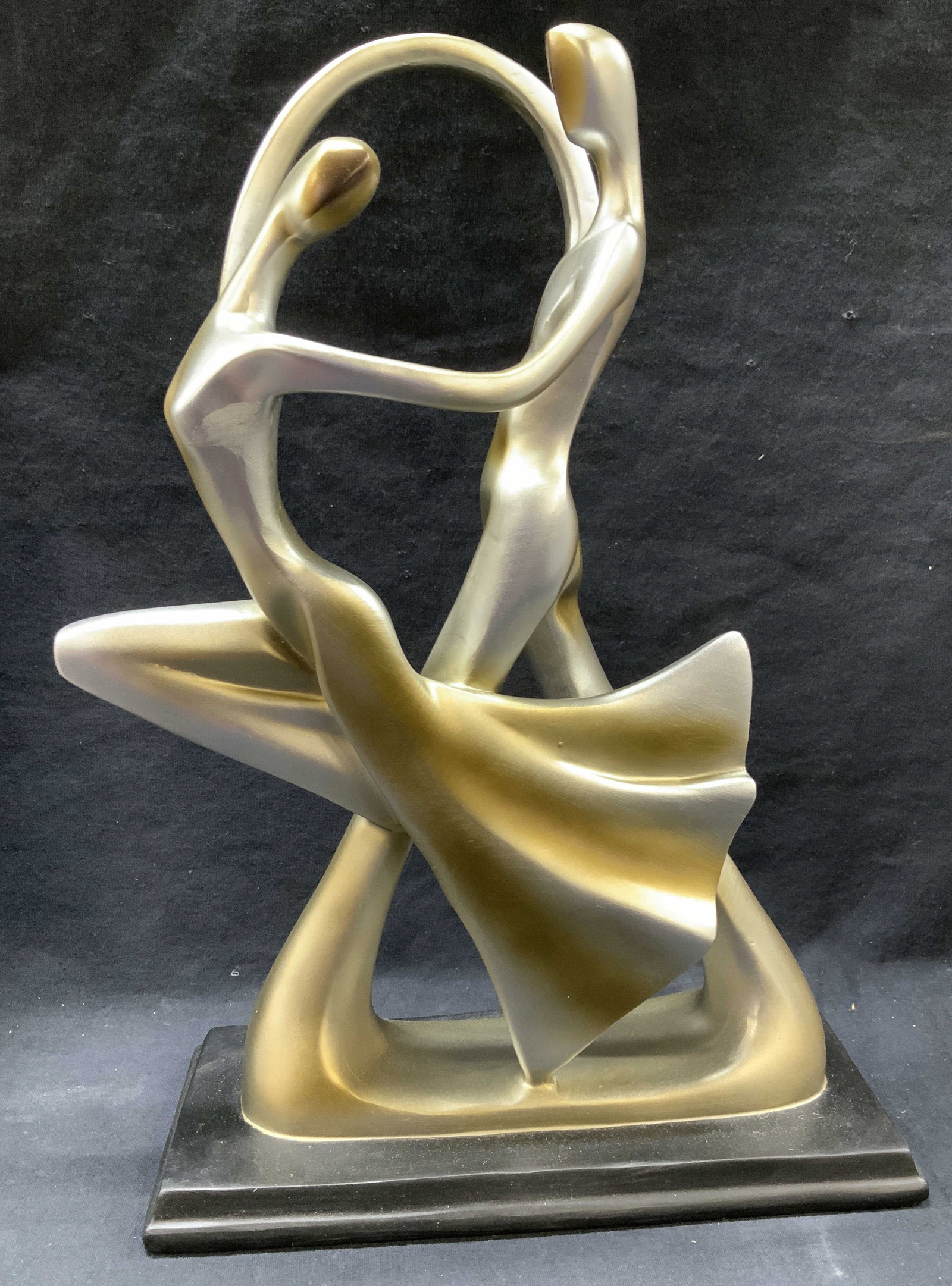 Art Deco Dancer Sculpture by Studio 55D, 14in: Flowing abstract art deco dancer sculpture with a sprayed Silver Finish. Resin composite sculpture and fiberglass base. From the Studio 55D brand of home decor accents. Measures 14.5 in. Tall, 11.5 in