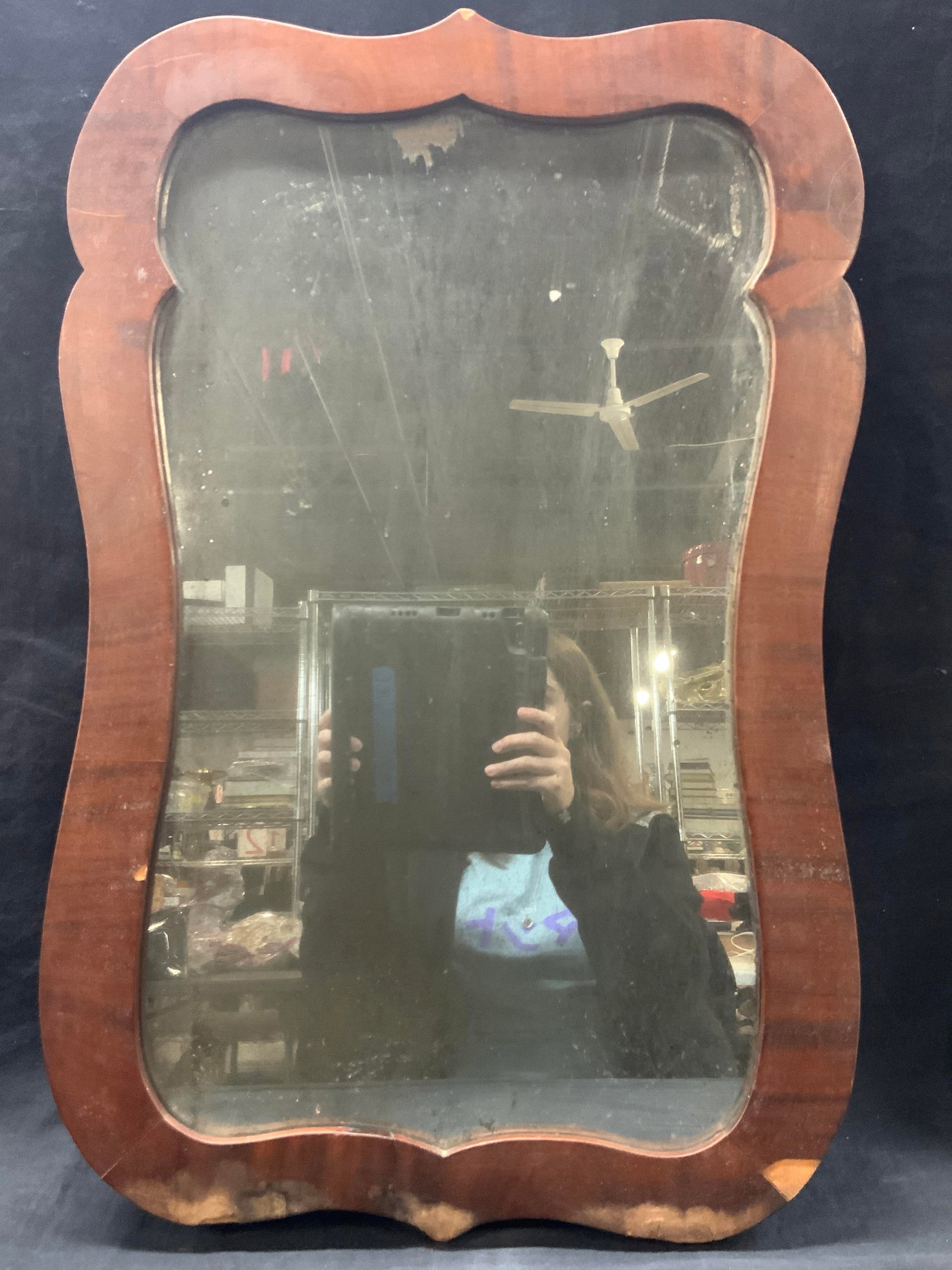 Red Wood Framed Wall Mirror 2ft: Wall mirror made with a red toned wooden finishes frame, approx 25 x 17 inches and glass measures 21 x 11.25 inches Evident discoloration and blemishes to frame due to water damage. Wooden wall mirror