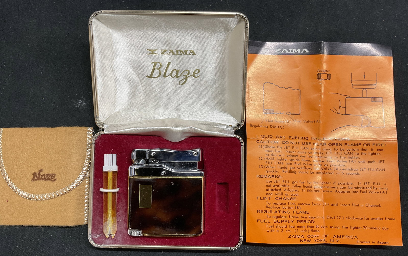 Vintage ZAIMA BLAZE Gas Fuelled Lighter In Box: Vintage ZAIMA BLAZE Gas Fuelled Lighter In original Box with cloth pouch and refill adapter. Base is marked BLAZE PAT 407793 209596 JAPAN. Not tested for working condition. Some surface wear consisten