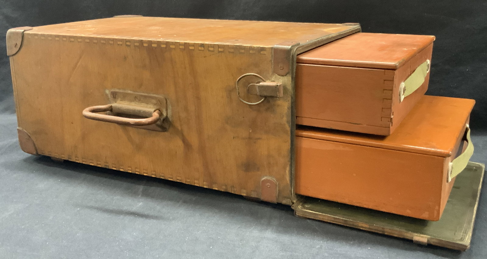 Vintage WWII Wooden Travel Crate: Vintage wooden WWII travel crate with side latch that unhooks and holds two orange toned wooden boxes with folding tops. Main crate has dove tail edges and leather affixed to corners and top handle ma