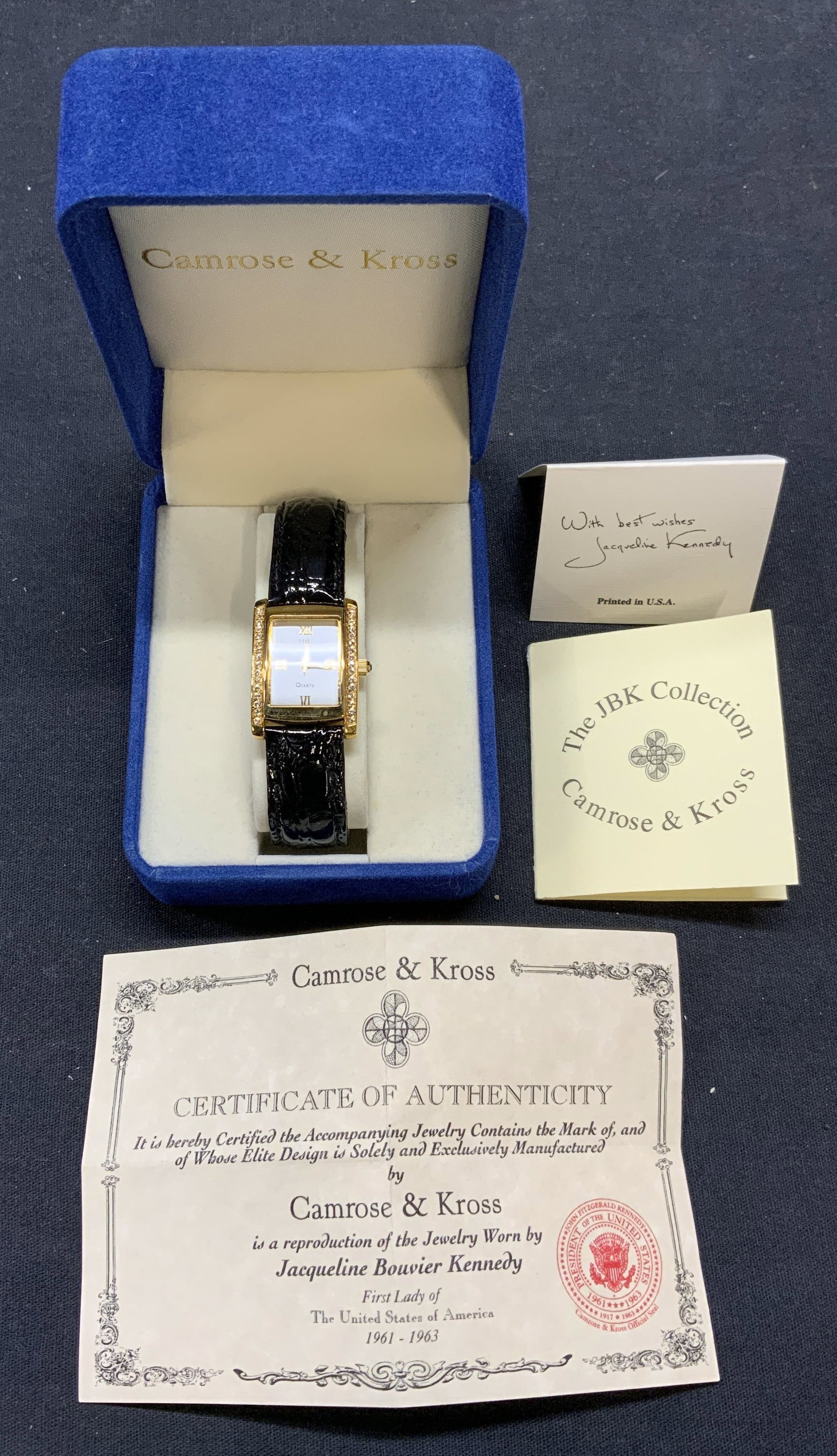 JBK Jacqueline Kennedy Leather Crystal Watch: JBK Jacqueline Kennedy watch with gold tone and crystal decorated face and leather strap. Signed on watch face. Measures approx. 6 inches long. Not tested for function. In good condition. Includes jew