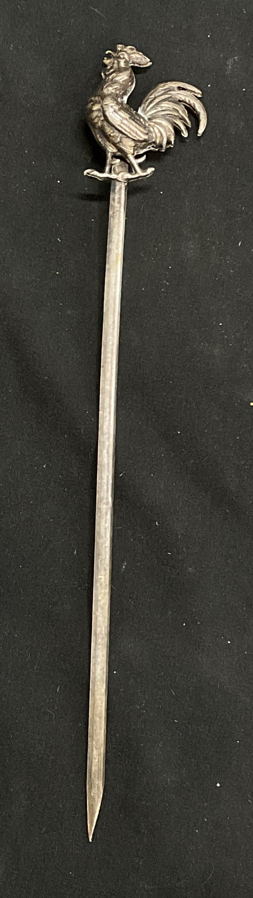 Vintage Silver Plate Rooster Skewer: Vintage Silver Plate Rooster Skewer. Measures approx. 9.25L x 1.5W in. Measured at widest point. Some surface wear consistent with age, and use. Property of Manhattan estates and fashion industry exec