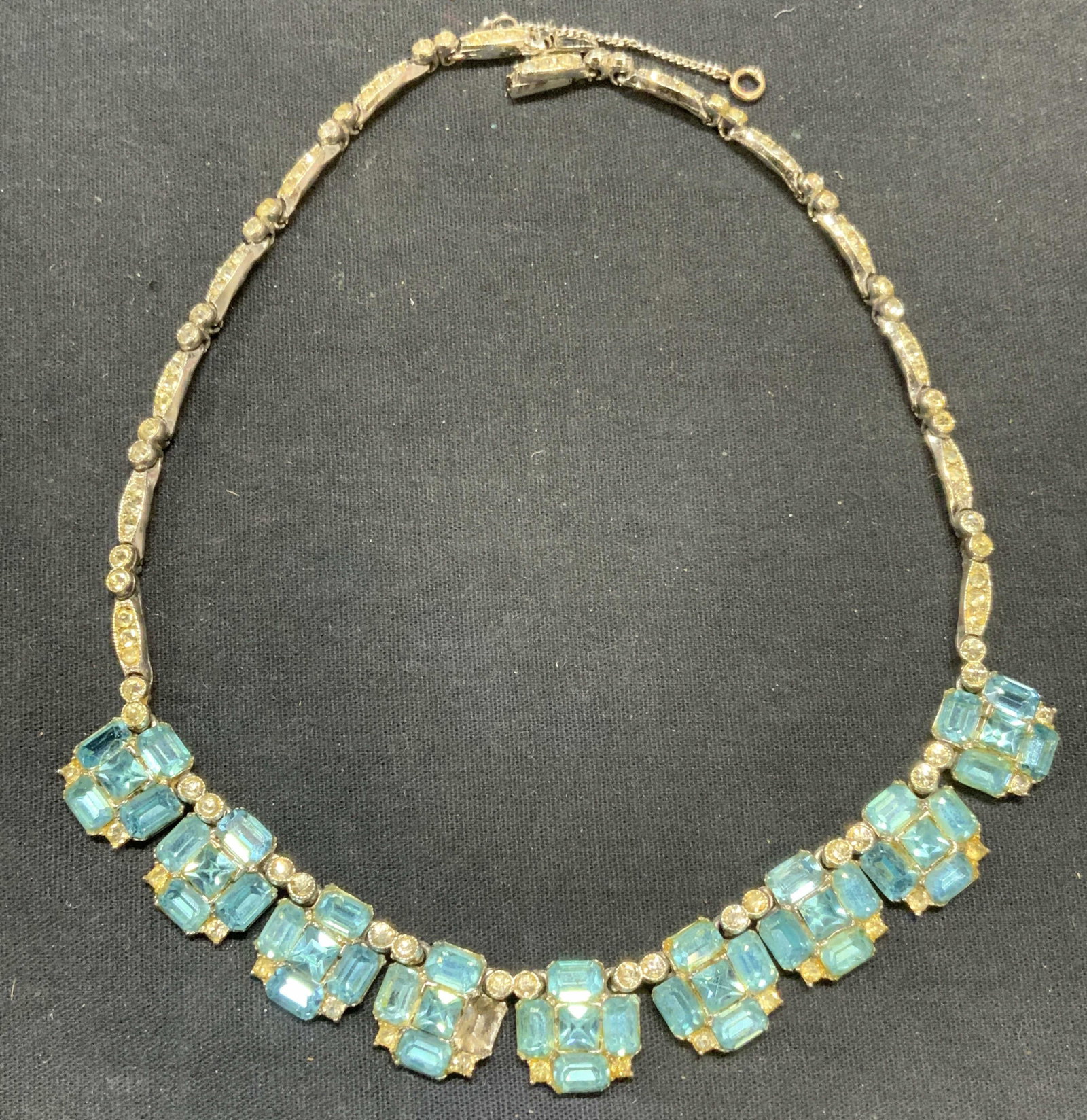 Vintage Bogoff Silver Tn Blue Crystal Necklace: Vintage Bogoff silver tone necklace with blue and colorless crystal decoration. Signed to clasp. Drop length approx. 7 inches. Some scratching observed. Some crystals needs replacement. Estate jewelry