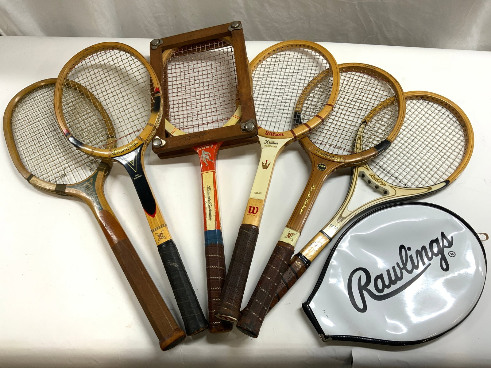 Lot 6 Vintage Wooden Tennis Rackets: Lot includes 6 tennis rackets. Each are vintage and wooden. Includes brands such as WILSON, RAWLINGS, VICTORY, CAMBRIDGE, & HUDSON. Each tennis most rackets have oval shaped head, 1 racket rectangular
