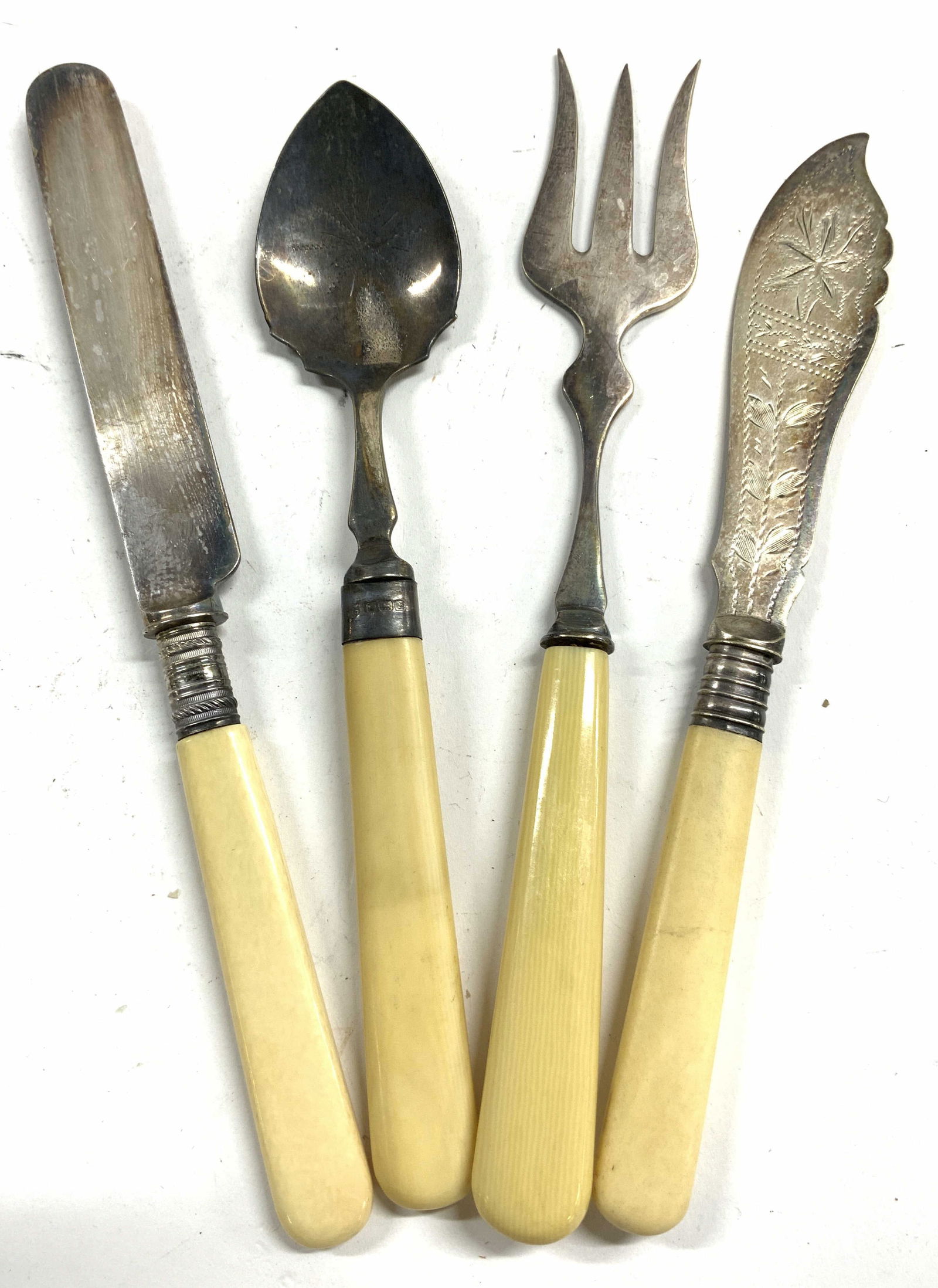 Lot 4 Bone Handle EPNS Utensils Serveware: Lot includes 1 Bread fork, 1 jam spoon, 1 dinner knife & 1 Pate knife. Each are Electro Plated Nickel Silver with cream toned bone handles. Largest piece (knife) measures approximately 8 inches long.