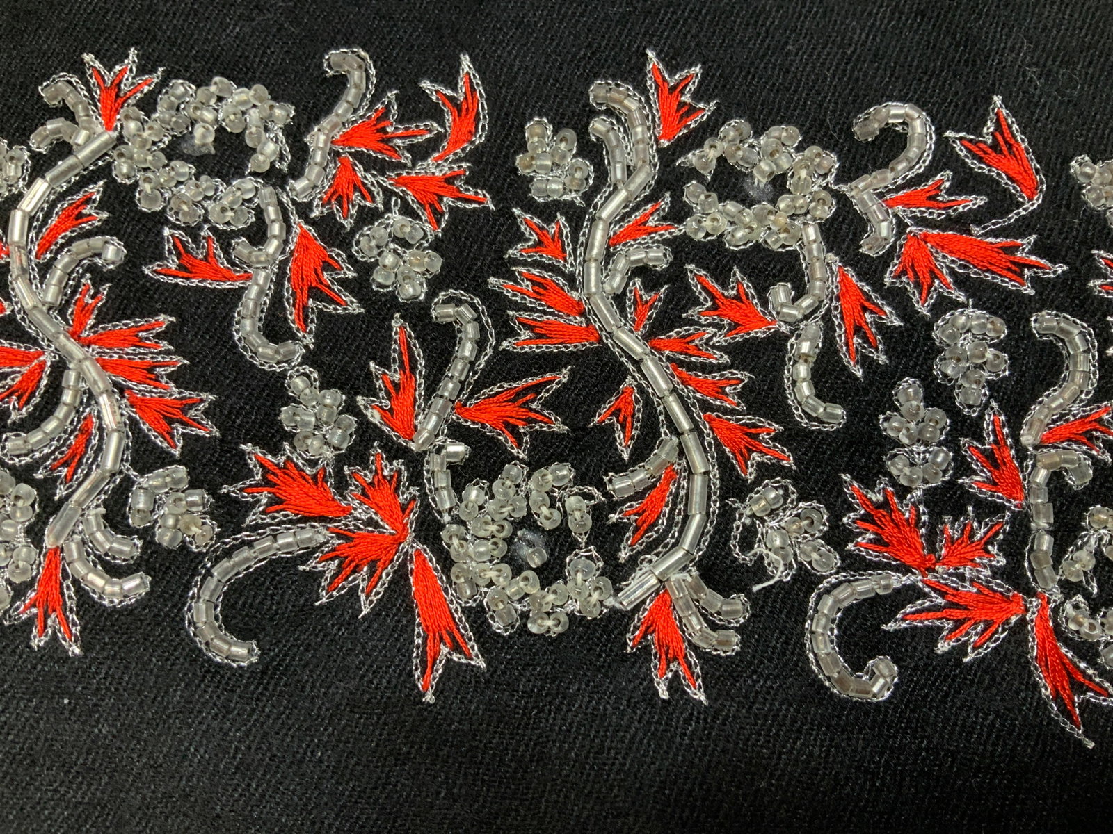 Cashmere Embroidered & Beaded Black Tassel Shawl: Oversized black cashmere shawl with end tassels, singular border of red and silver embroidery with clear seed beads on each end. Soft hand. No labels. 35 x 83 in. approx. Embroidered and beaded black 