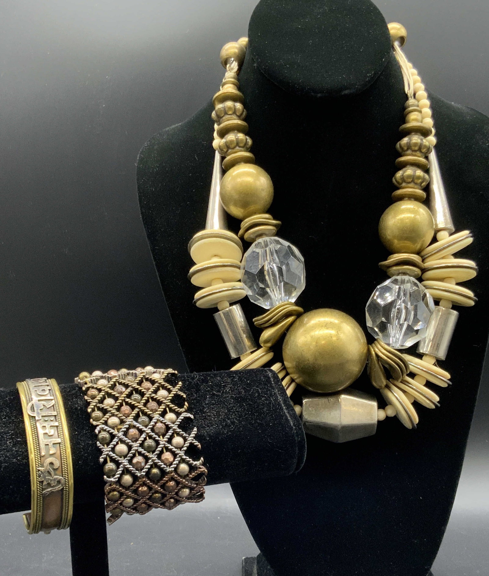 Lot 4 Vintage Necklaces & Bracelets, VCLM & More: Two vintage necklaces and two vintage bracelets. The necklaces are chunky and feature brass or silver tone metal beads. Faceted colorless beads or bone, possibly resin, discs to the necklaces as well.
