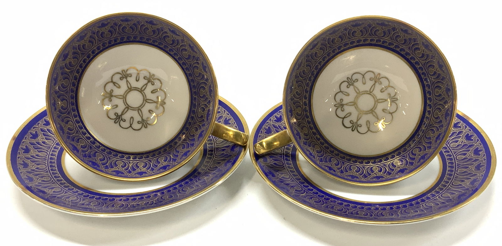 Set4 Tirschenreuth Cobalt Porcel Demitasse Germany: 2 pair of Bavarian German Porcelain demitasse tea cups with saucers. P.T. Tirschenreuth 978 2443 footed cups and saucers, hallmarked. Cobalt with intricate hand painted gilt work on bright white porce